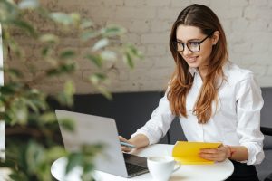 Happy business woman using laptop computer