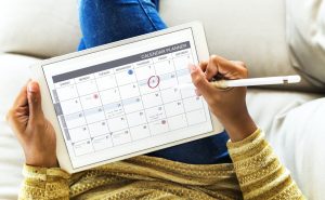 Woman checking calendar on digital tablet